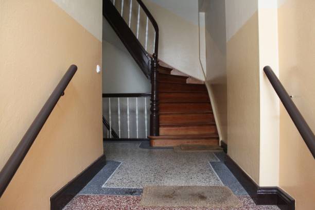 istock Dark brown wooden staircase in a building 1267935258