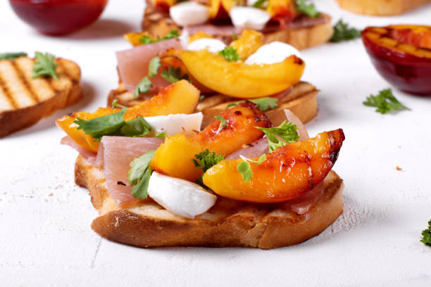 istock Bruschetta with grilled peaches, prosciutto and mozzarella 1267936000