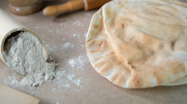 istock Kuboos or khubz - Arabic bread on a brown table in the kitchen 1267936531