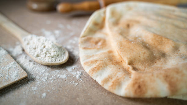 istock Kuboos or khubz - Arabic bread on a brown table in the kitchen 1267936613