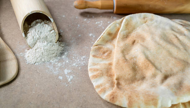 istock Kuboos or khubz - Arabic bread on a brown table in the kitchen 1267936658