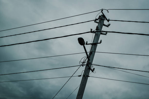 istock Concrete pole with electricity line cables and a lamp. 1267938577