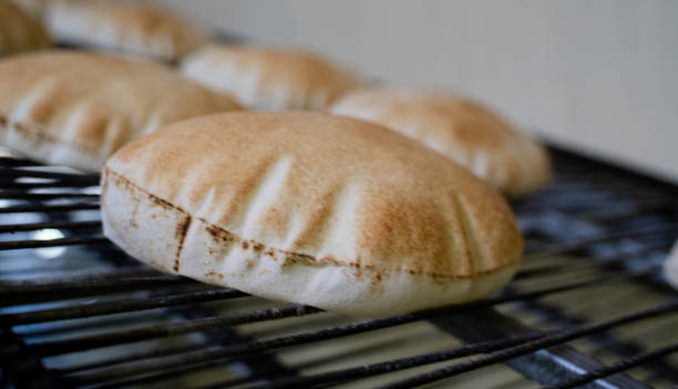 istock Background image of arabic bread produced in a machine.Arabic bread production 1267938991