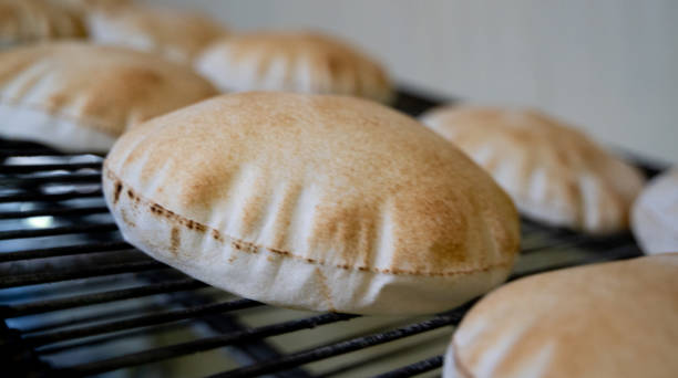 istock Background image of arabic bread produced in a machine.Arabic bread production 1267939011