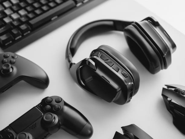 istock gamer work space concept, top view a gaming gear, mouse, keyboard, joystick, headset, mobile joystick, in ear headphone and mouse pad on black table background. 1267943722