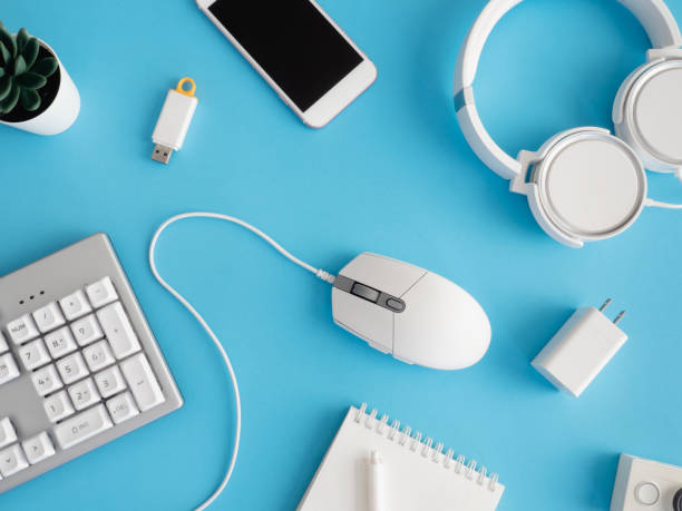 istock top view of office desk table with notebook, plastic plant and keyboard on blue background, graphic designer, Creative Designer concept. 1267943735