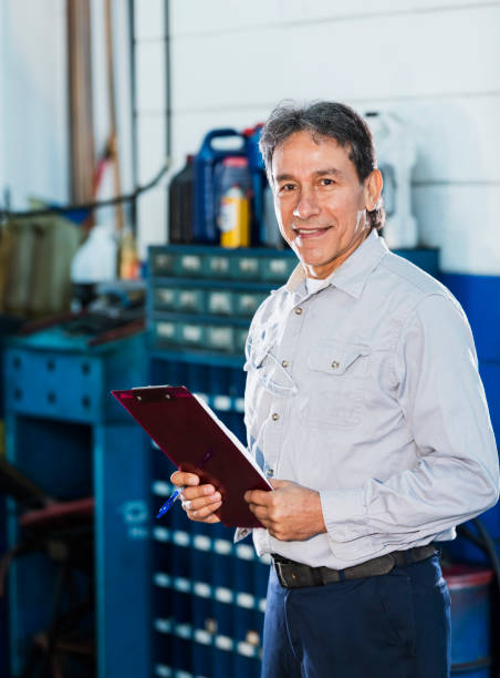 istock Senior Hispanic man working in auto repair shop 1267943944