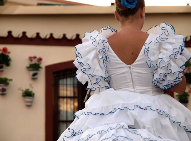 Fuengirola, Malaga, Spain. October, 10, 2010.  Young women in flamenco costumes on horseback during the October Fair in Fuengirola in honor of the Virgen del Rosario.