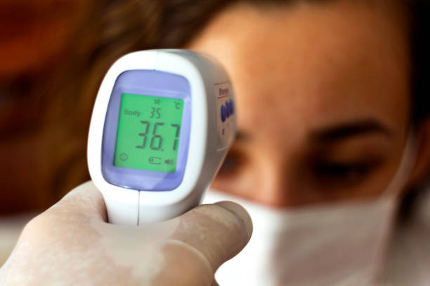 istock Hand holding infrared thermometer measuring fever 1267953802
