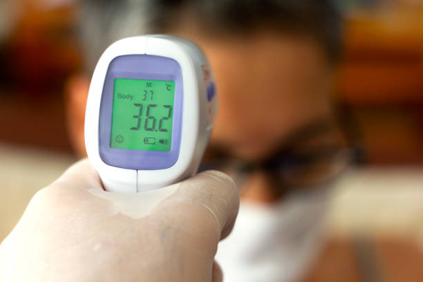 istock Hand holding infrared thermometer measuring fever 1267953904
