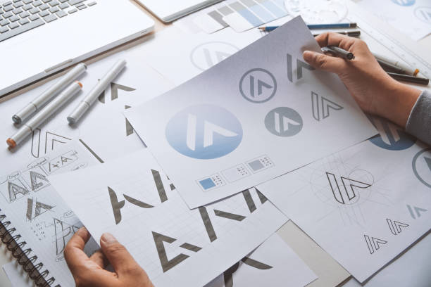 istock Graphic designer creative design sketch drawing logo Trademark brand Workspace 1267954115
