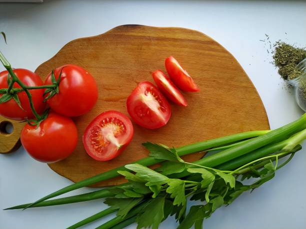 istock freshly cut celery, tomatoes, green onion on wooden cutting board 1267956031