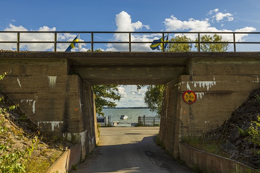 Road to Baltic Sea through the arch of the railway bridge.
