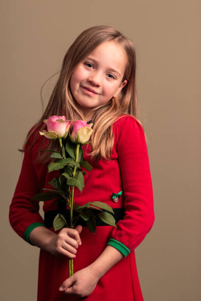 istock Pretty young girl holding flowers 1267965112
