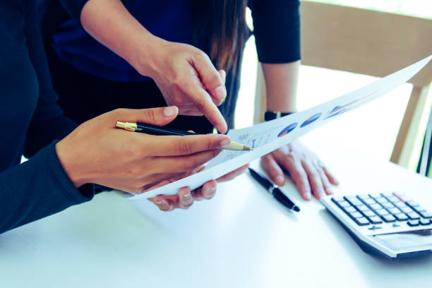 istock business team hands searching for data on mobile phone  with analyzing charts at his workplace. 1267988354