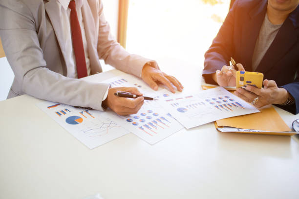 istock business team hands searching for data on mobile phone  with analyzing charts at his workplace. 1267988891