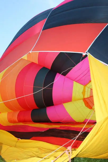 Preparation of a multicolored hot air balloon close-up, seen inside
