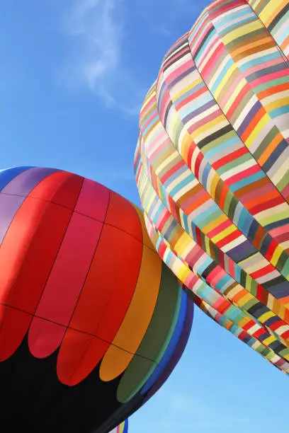 Multicolored hot air balloons close-up on blue sky