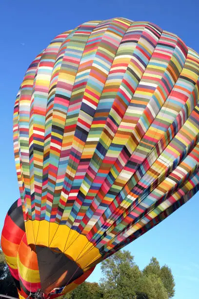 multicolored hot air balloon prepared for takeoff