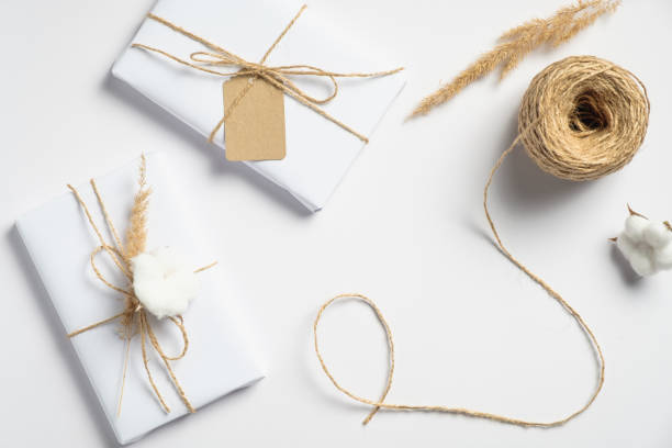 istock Handmade Christmas presents and string rope on white background. Christmas, winter holidays, New year preparations concept. Flat lay style, top view 1267992985