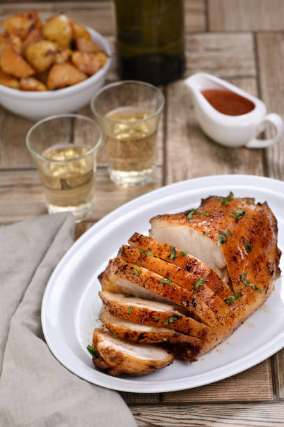istock Sliced  into slices baked turkey breast   at the dinner table 1267994881