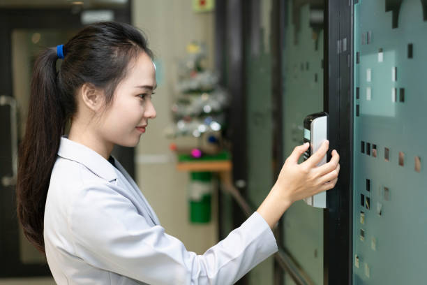 istock Woman scanning fingerprint and access control for enter security system in a office building 1267995384