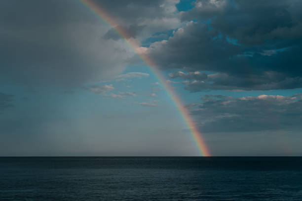 istock Wonderful rainbow over the sea 1267996597
