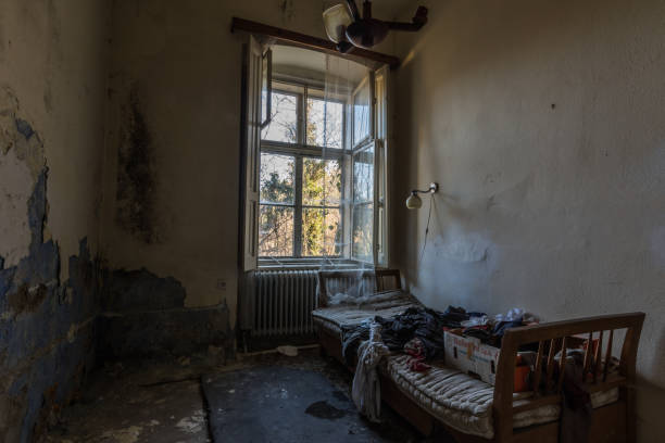 istock abandoned hotel room with bed and open windows 1267997265
