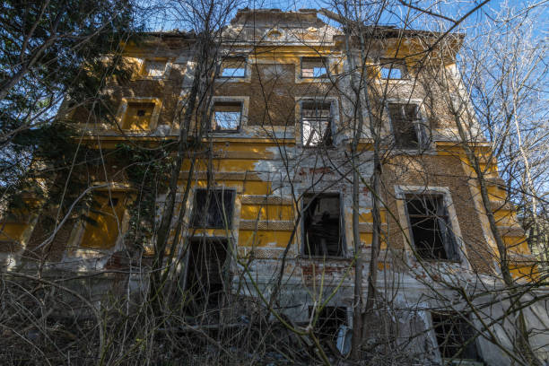 istock dilapidated ruined yellow house 1267997290
