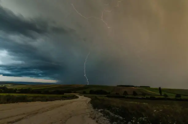 thunderstorm with rain clouds and lightning in the landscape