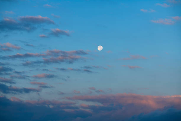 istock Beautiful full moon on the sunrise sky. Astronomical background. 1267999799