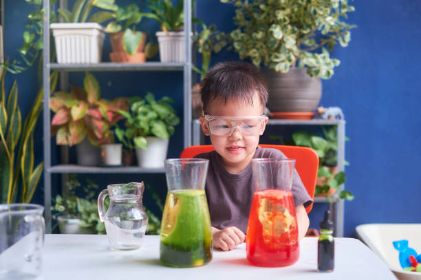 Asian school kid studying science, making DIY Lava Lamp Science Experiment, Kid-friendly fun and easy science experiments at home concept