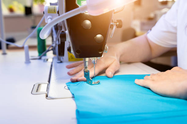 istock Designer tailor sew the dress. Woman use sewing machine for his work. 1268007148