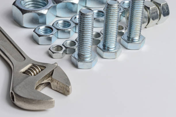 istock screw-nut of different sizes, bolts and adjustable spanner. 1268011419