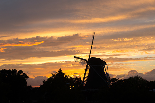 Sint Anna windmill (Nijmegen, The Netherlands) during sunset with dramatic cloudy sky