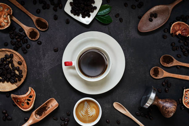 cup of coffee and coffee composition on black background. copy space. top view. flat lay. - napkin black blank ideas imagens e fotografias de stock