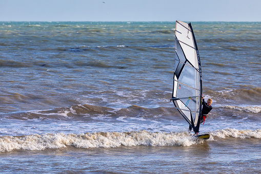 Eastbourne, UK - Aug 21, 2020. A windsurfer sufing in a beach of Eastbourne of East Sussex.