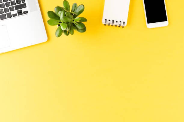 istock Office desktop. Elegant laptop with business accessories on yellow background 1268017790