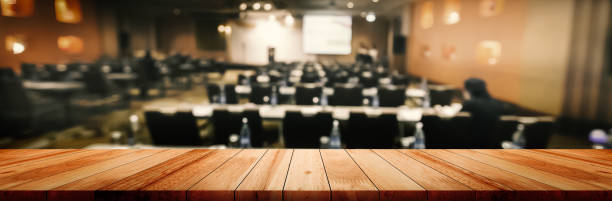 panoramic empty clean wood counter table top on blur student study in classroom white light background for product education learning hall centre, abstract blurry wooden desk scene display or montage. - medical exam fotos imagens e fotografias de stock