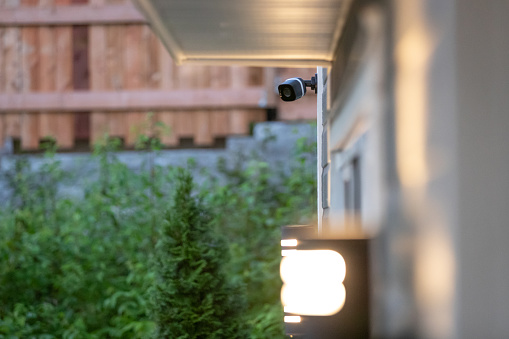 Black cctv surveillance camera outside building, home security system
