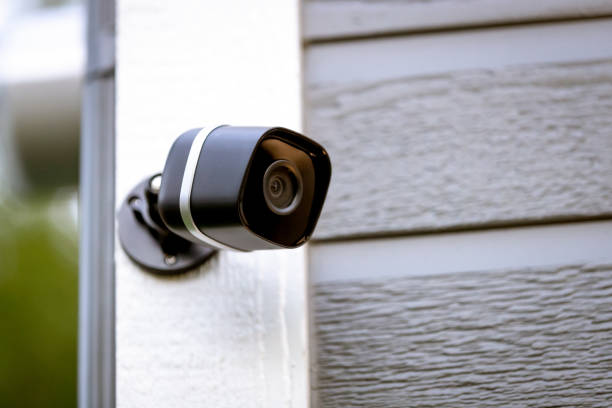 istock Black cctv surveillance camera outside building, home security system 1268020553