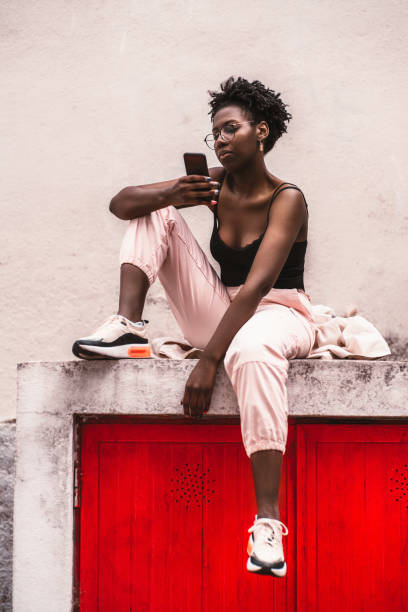 istock Black woman with cellphone outdoors 1268020568