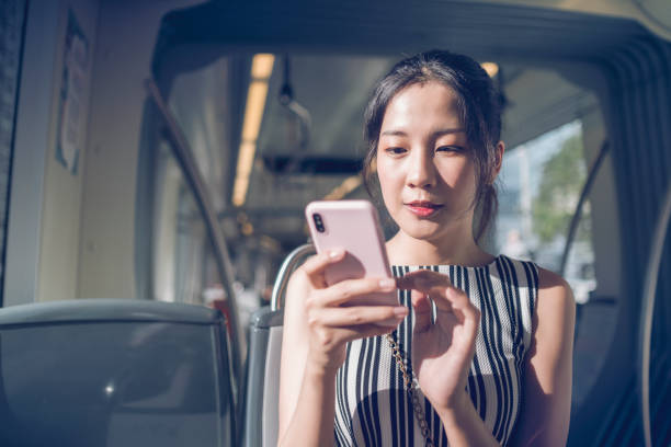 istock Young woman using mobile phone while commuting with the subway in the city 1268022988