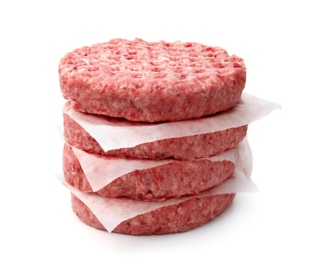 Stack of fresh raw burger patty isolated on white