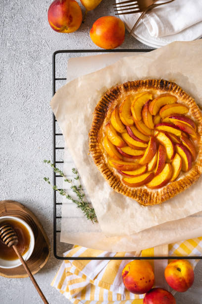 istock Peach galette, pie, cake with honey on grey background. Copy space. Top view. 1268023289