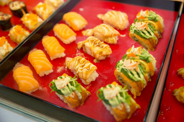istock Salmon spicy sushi put on red wood, in focus selective. 1268023392