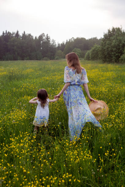 istock mother and daughter in dresses and a hat stand 1268024606