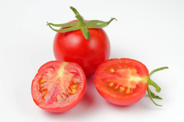 istock Fresh organic tomato with halves on a white background, bright natural color, 1268024887