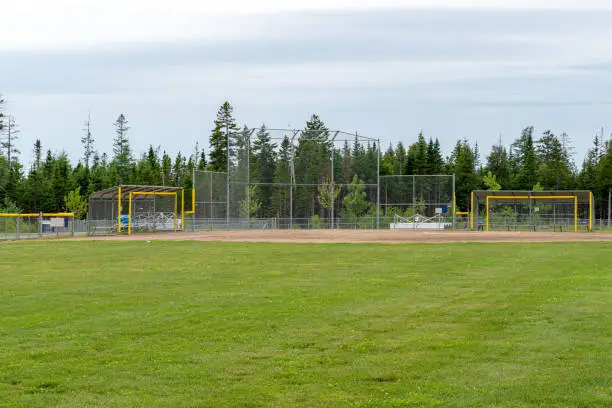 An empty baseball field beneath an overcast sky. Wide, distant view.