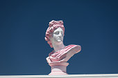 Modern conceptual art colorful ancient statue of bust of Apollo. Stock photo.
